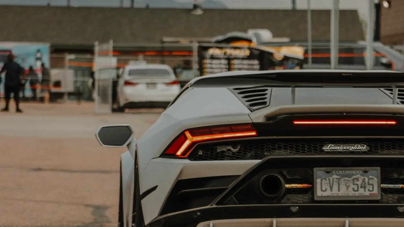 Silver Lamborghini Huracán rear at dusk — widebody build